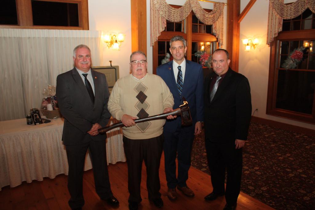 Chief Jaye Graham receiving a commemorative axe with Deputy Chief Dave Syka, Assistant Chief Dave Przybysz and Banquet Chairman / Vice President Jason Gallagher
